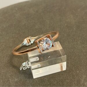 bracelet featuring large round clear gemstone set within square open-sided frame